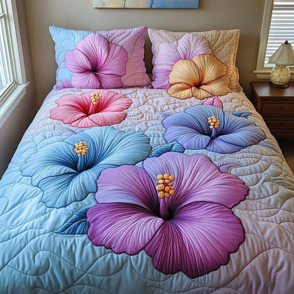 Hibiscus Dreams quilted 3-piece bedding set on a made bed with two matching pillow shams