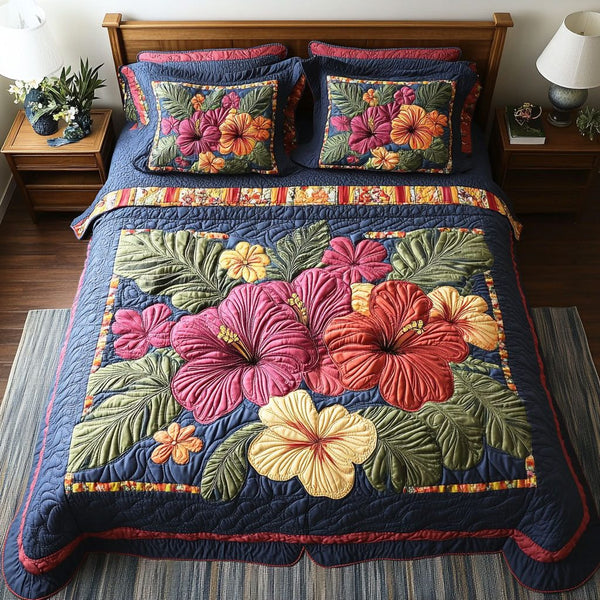 Hibiscus Oasis quilted 3-piece bedding set on a made bed with two matching pillow shams