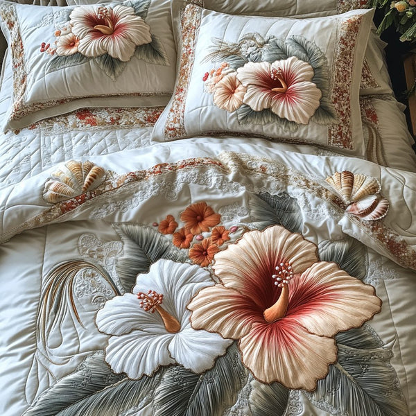 Hibiscus Pearl quilted 3-piece bedding set on a made bed with two matching pillow shams