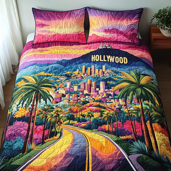 Hollywood Los Angeles quilted 3-piece bedding set on a made bed in a softly lit bedroom