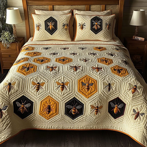 Honey Bee Dreams quilted 3-piece bedding set on a made bed with two matching pillow shams