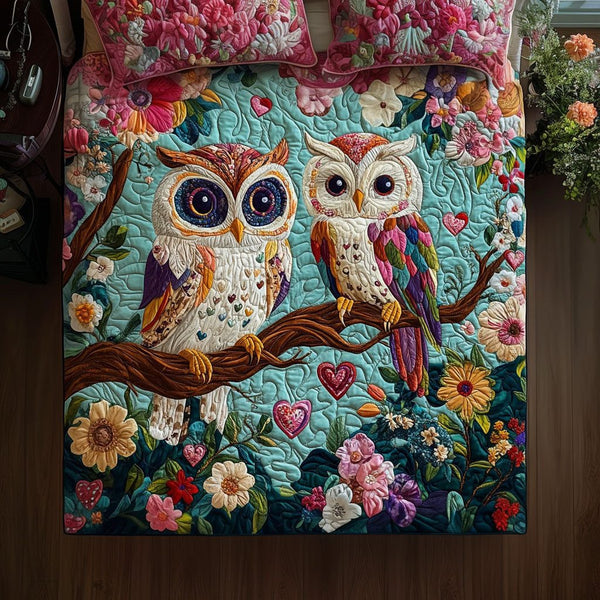 Hooting Hearts quilted 3-piece bedding set on a made bed with two matching pillow shams