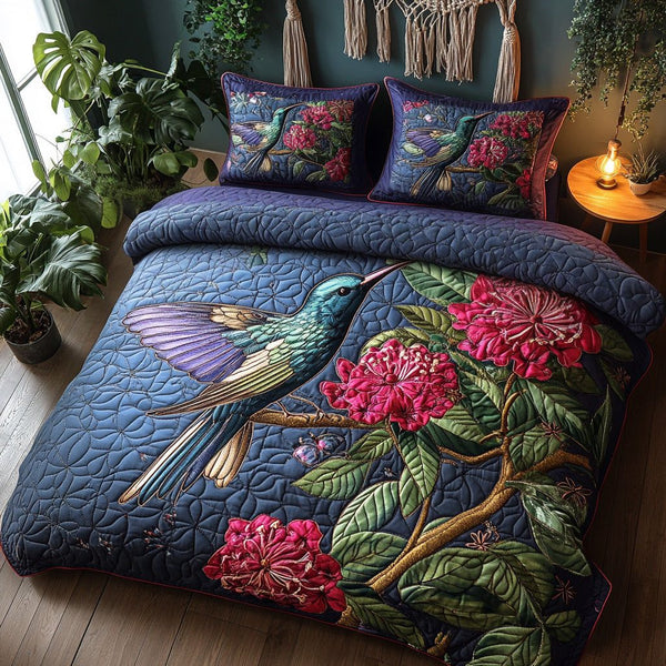 Humming Bloom quilted 3-piece bedding set on a made bed with two matching pillow shams