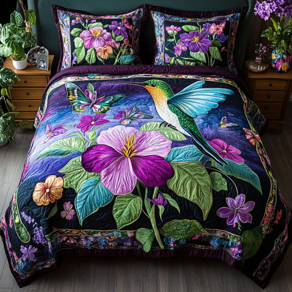 Hummingbird Bliss quilted 3-piece bedding set on a made bed with two matching pillow shams