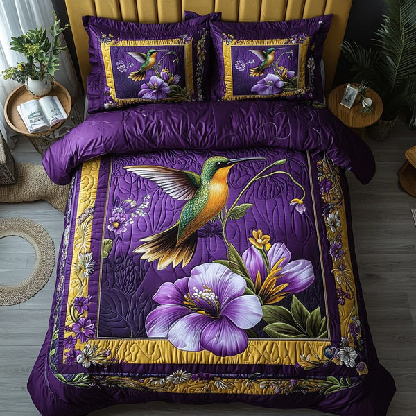 Hummingbird Bliss quilted 3-piece bedding set on a made bed with two matching pillow shams
