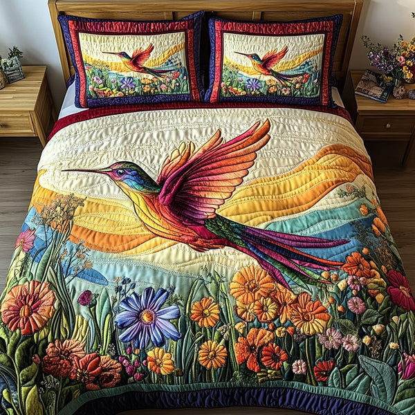 Hummingbird Bliss quilted 3-piece bedding set on a made bed with two matching pillow shams