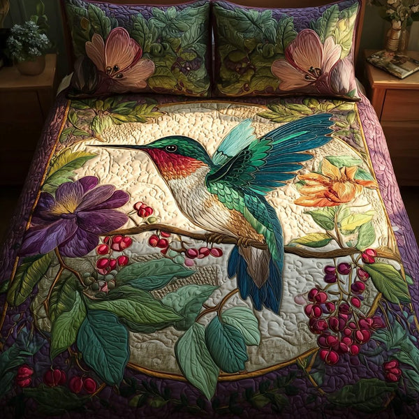Hummingbird Bloom quilted 3-piece bedding set on a made bed with two matching pillow shams