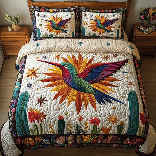 Hummingbird Cactus Flight quilted 3-piece bedding set on a made bed with two matching pillow shams