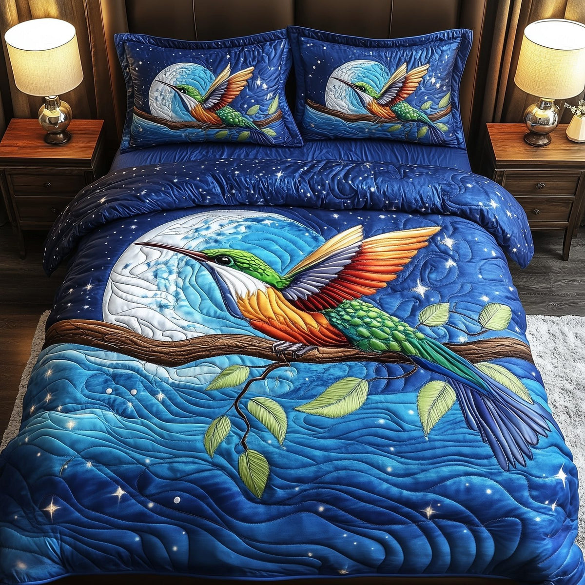 Hummingbird Charm quilted 3-piece bedding set on a made bed with two matching pillow shams