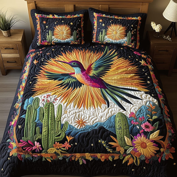Hummingbird Desert Symphony quilted 3-piece bedding set on a made bed with two matching pillow shams