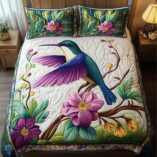 Hummingbird Dream quilted 3-piece bedding set on a made bed with two matching pillow shams