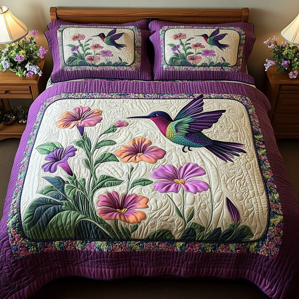 Hummingbird Dream quilted 3-piece bedding set on a made bed with two matching pillow shams