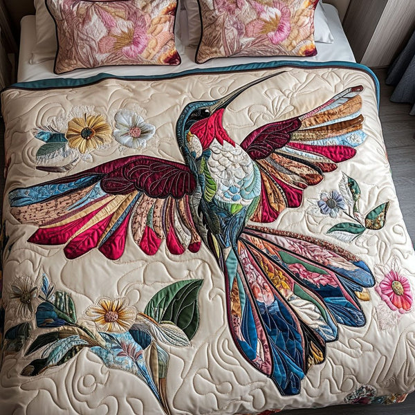 Hummingbird Elegance quilted 3-piece bedding set on a made bed with two matching pillow shams