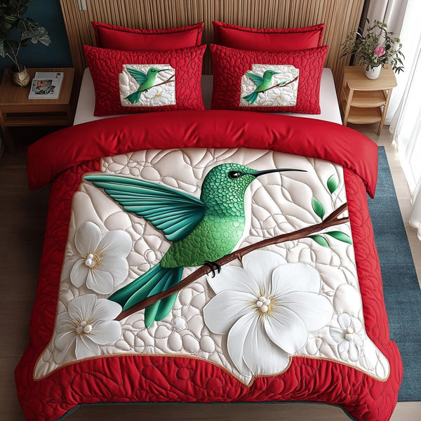 Hummingbird Flight quilted 3-piece bedding set on a made bed with two matching pillow shams