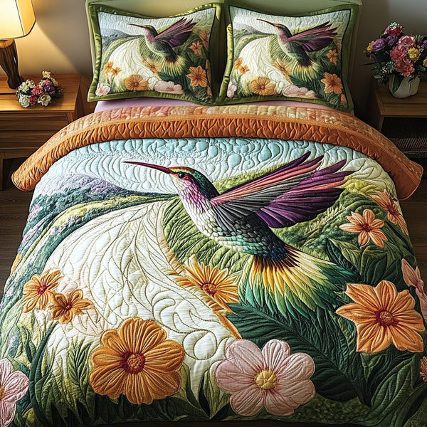 Hummingbird Flight quilted 3-piece bedding set on a made bed with two matching pillow shams