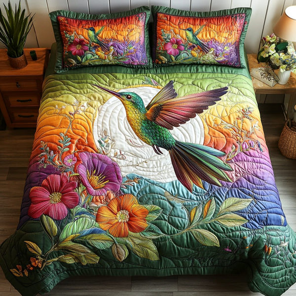 Hummingbird Garden quilted 3-piece bedding set on a made bed with two matching pillow shams