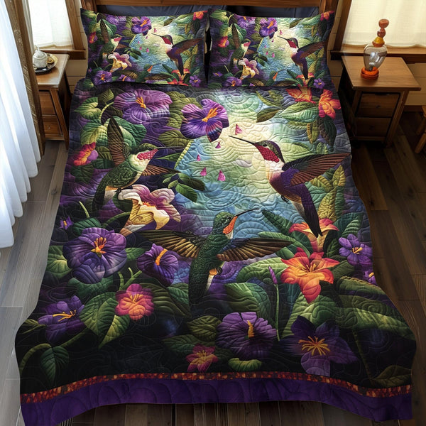 Hummingbird Garden quilted 3-piece bedding set on a made bed with two matching pillow shams
