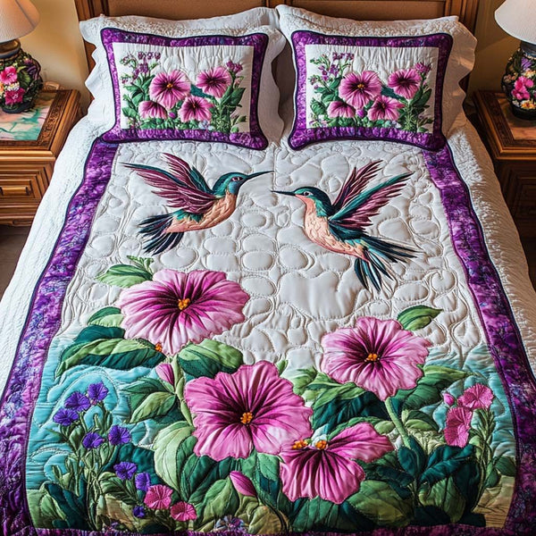 Hummingbird Harmony quilted 3-piece bedding set on a made bed with two matching pillow shams