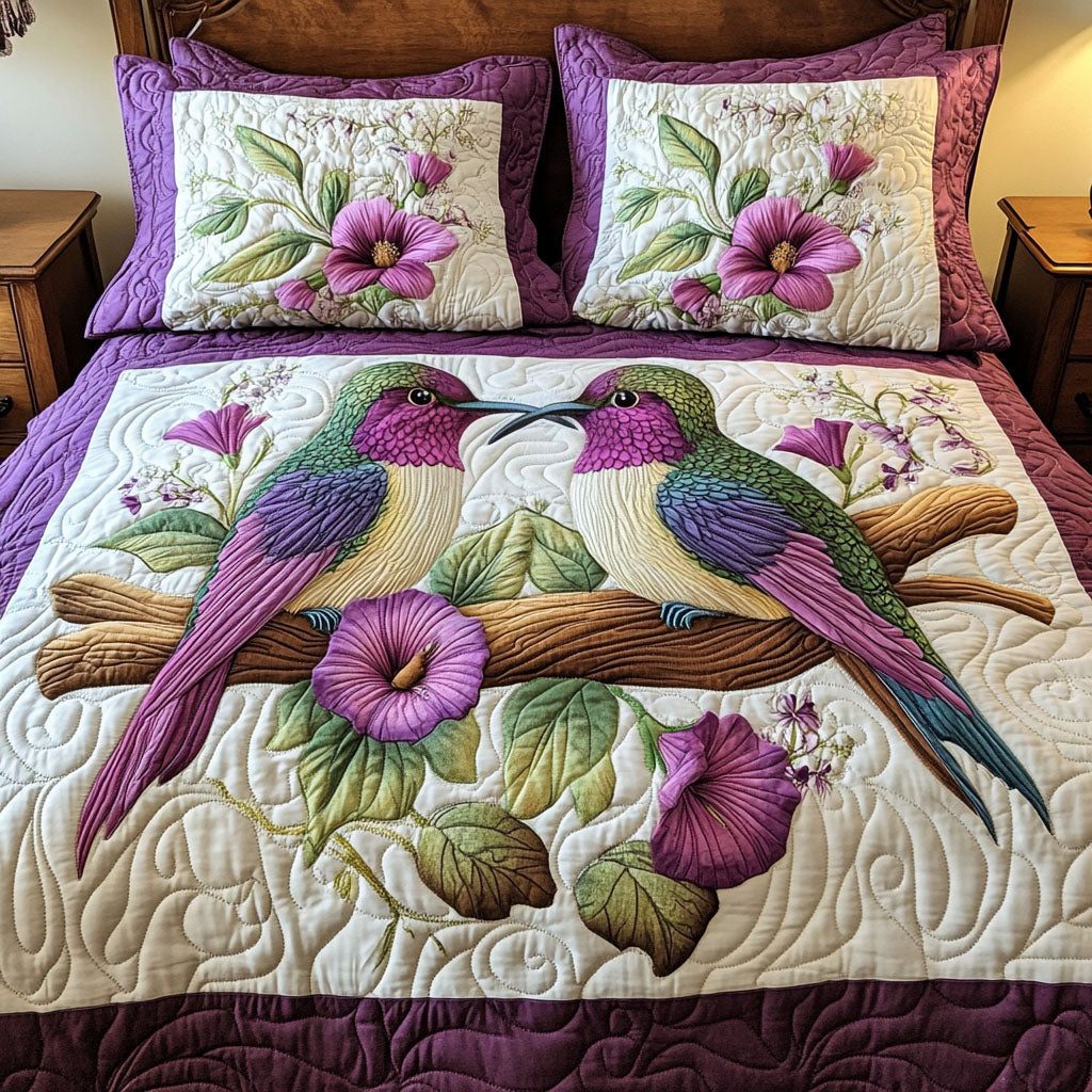 Hummingbird Harmony quilted 3-piece bedding set on a made bed with two matching pillow shams