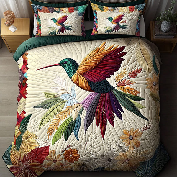 Hummingbird Harmony quilted 3-piece bedding set on a made bed with two matching pillow shams