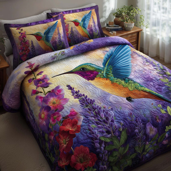 Hummingbird Haven quilted 3-piece bedding set on a made bed with two matching pillow shams