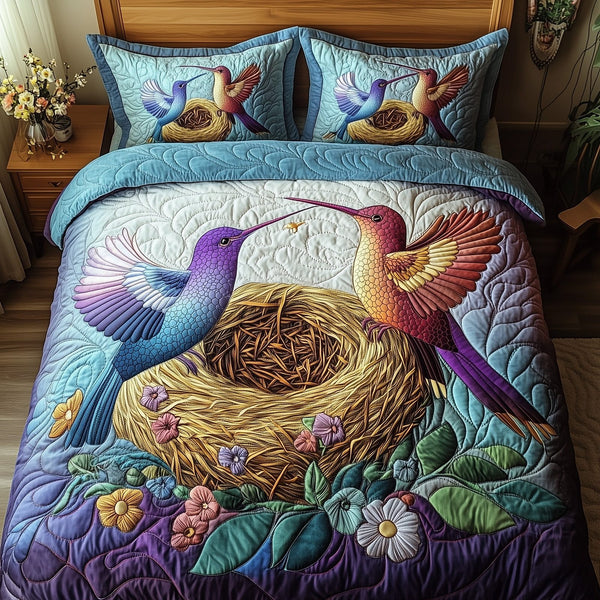 Hummingbird Haven quilted 3-piece bedding set on a made bed with two matching pillow shams