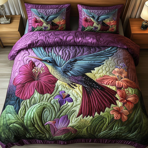 Hummingbird Haven quilted 3-piece bedding set on a made bed with two matching pillow shams