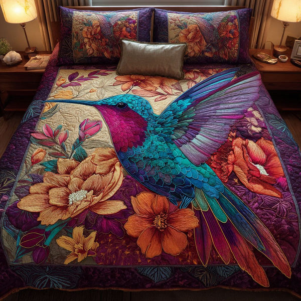 Hummingbird Haven quilted 3-piece bedding set on a made bed with two matching pillow shams