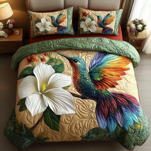 Hummingbird Haven quilted 3-piece bedding set on a made bed with two matching pillow shams