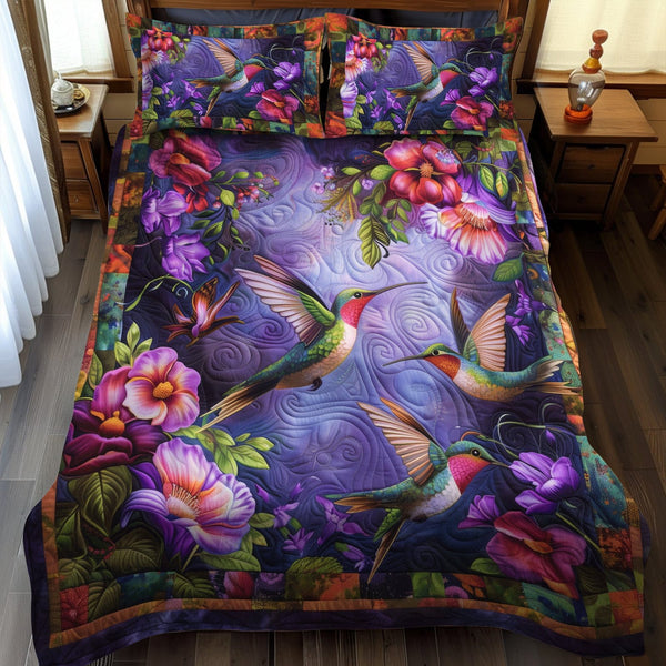 Hummingbird Haven quilted 3-piece bedding set on a made bed with two matching pillow shams