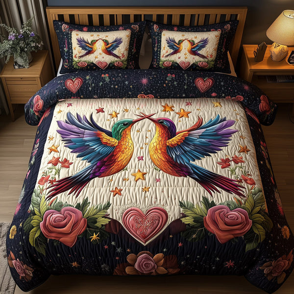 Hummingbird Heartstrings quilted 3-piece bedding set on a made bed with two matching pillow shams
