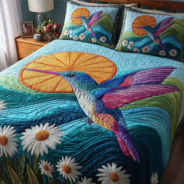 Hummingbird Heaven quilted 3-piece bedding set on a made bed in a softly lit bedroom
