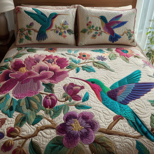 Hummingbird Heaven quilted 3-piece bedding set on a made bed in a softly lit bedroom