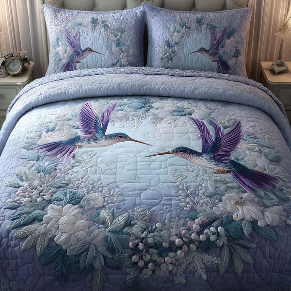 Hummingbird Heaven quilted 3-piece bedding set on a made bed in a softly lit bedroom
