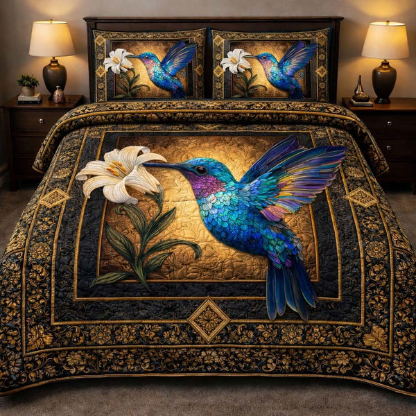 Hummingbird Heaven quilted 3-piece bedding set on a made bed in a softly lit bedroom
