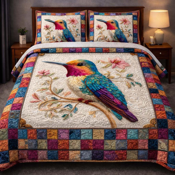 Hummingbird Heaven quilted 3-piece bedding set on a made bed in a softly lit bedroom