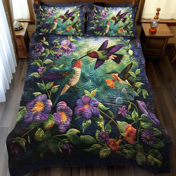 Hummingbird Kiss quilted 3-piece bedding set on a made bed with two matching pillow shams