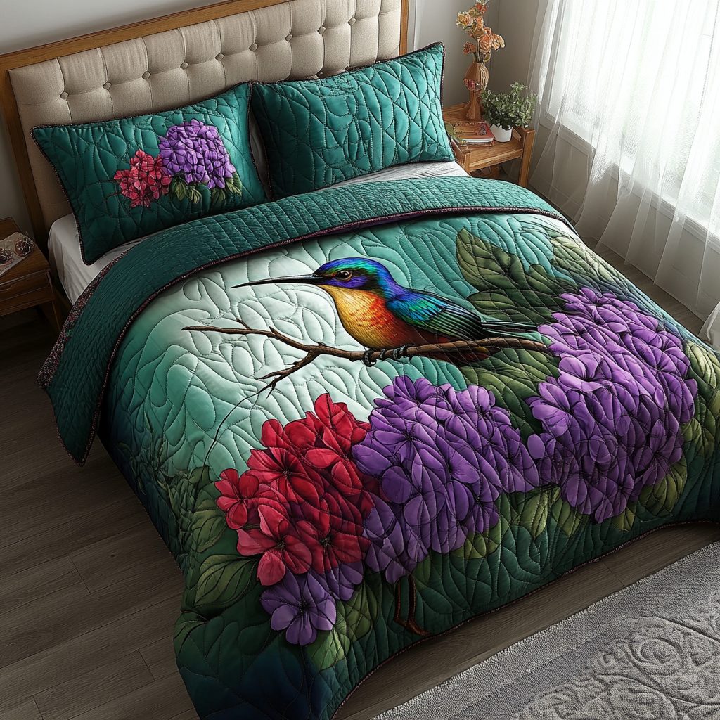 Hummingbird Lace quilted 3-piece bedding set on a made bed with two matching pillow shams