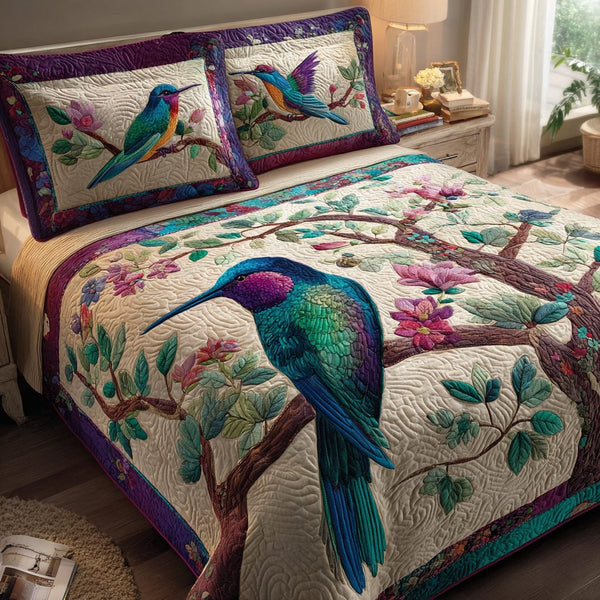 Hummingbird Light quilted 3-piece bedding set on a made bed with two matching pillow shams