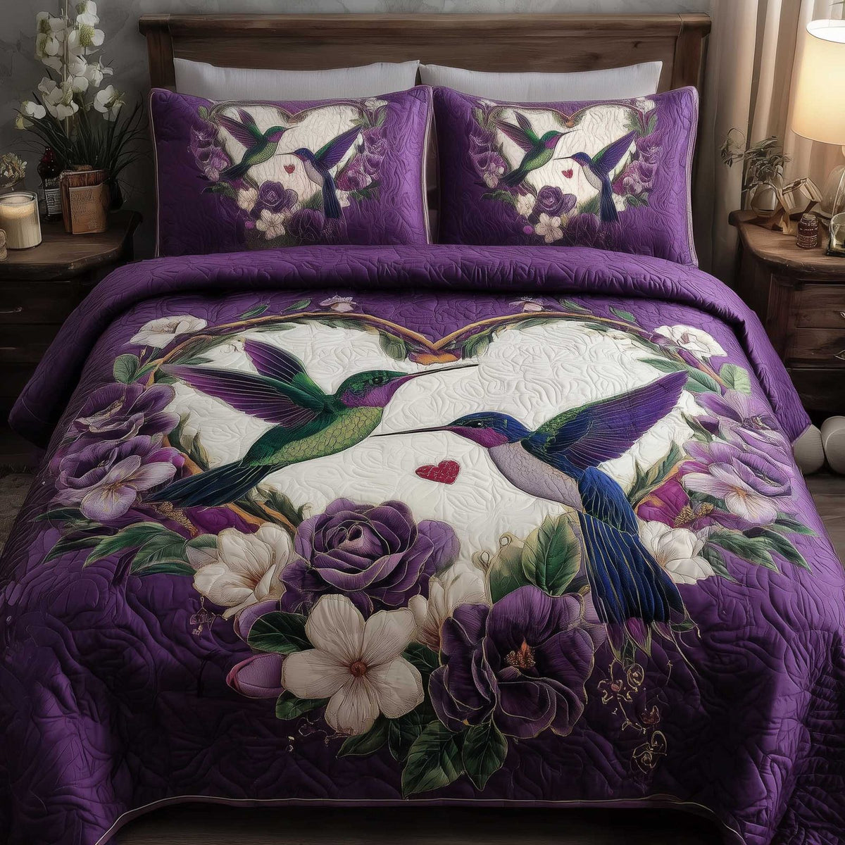 Hummingbird Love quilted 3-piece bedding set on a made bed with two matching pillow shams