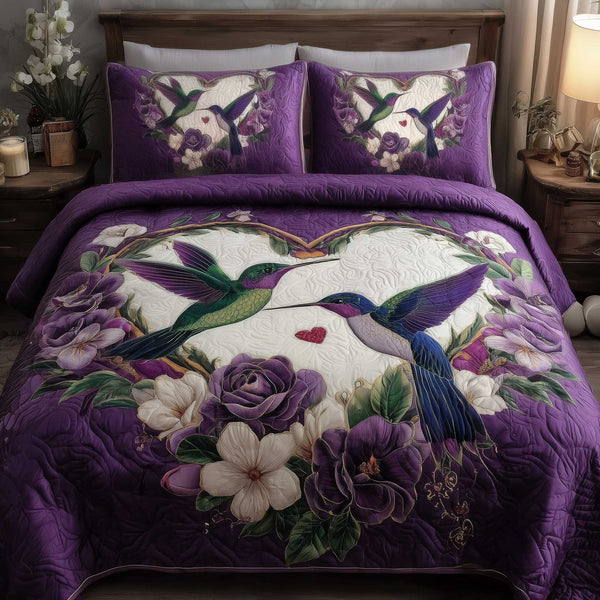 Hummingbird Love quilted 3-piece bedding set on a made bed with two matching pillow shams