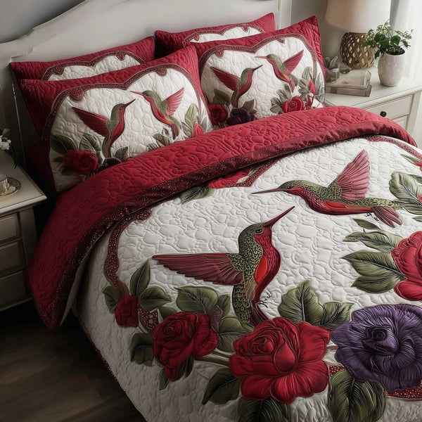 Hummingbird Love quilted 3-piece bedding set on a made bed with two matching pillow shams