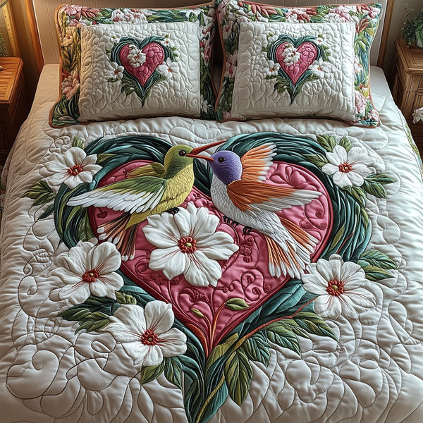 Hummingbird Love quilted 3-piece bedding set on a made bed with two matching pillow shams