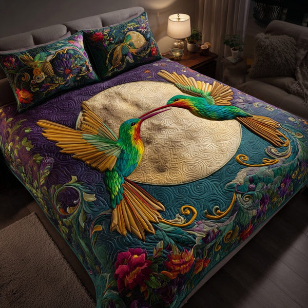 Hummingbird Magic quilted 3-piece bedding set on a made bed with two matching pillow shams