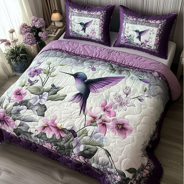 Hummingbird quilted 3-piece bedding set on a made bed with two matching pillow shams