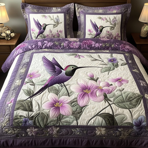 Hummingbird quilted 3-piece bedding set on a made bed with two matching pillow shams
