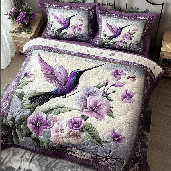Hummingbird quilted 3-piece bedding set on a made bed with two matching pillow shams