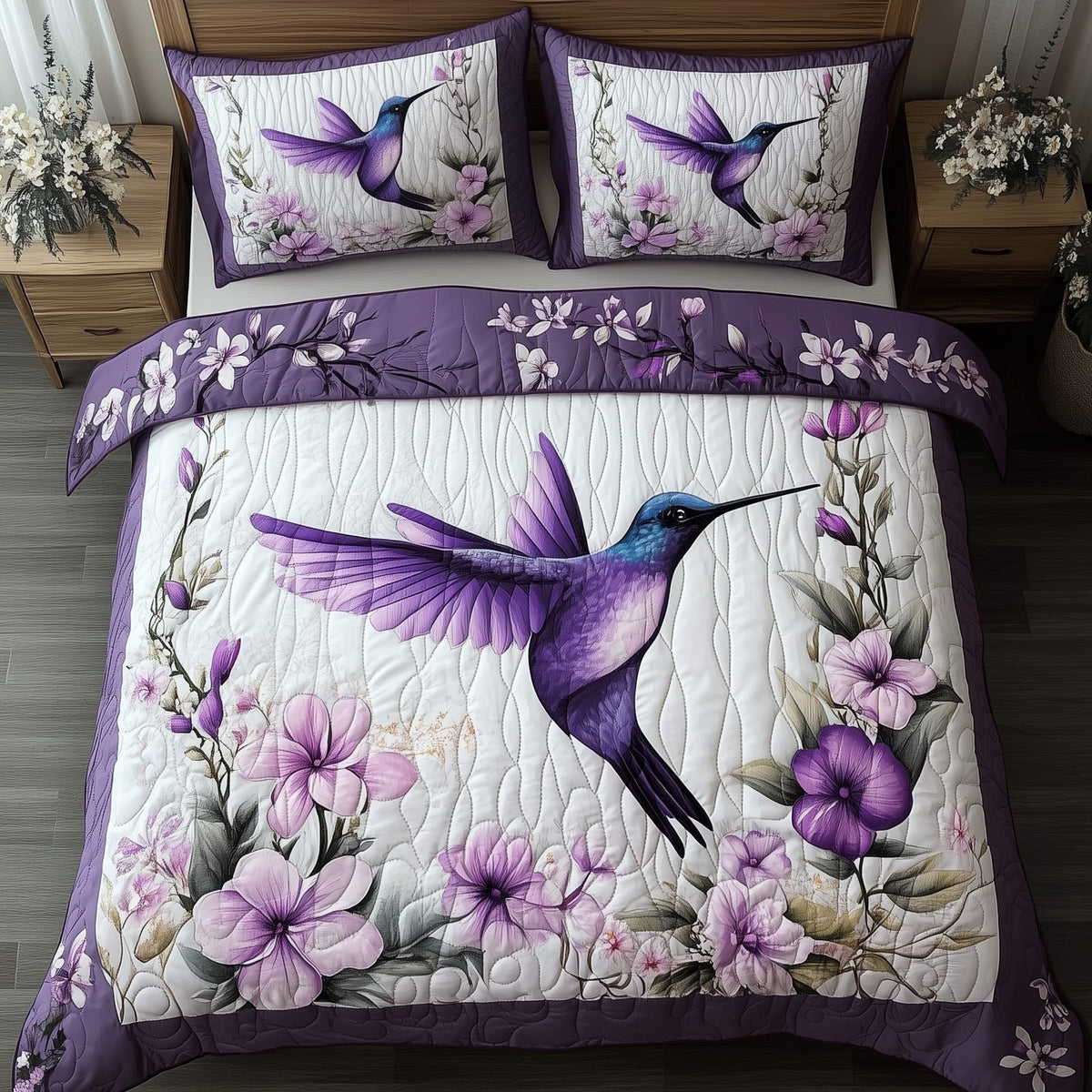 Hummingbird quilted 3-piece bedding set on a made bed with two matching pillow shams