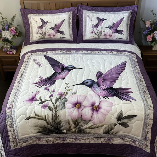 Hummingbird quilted 3-piece bedding set on a made bed with two matching pillow shams