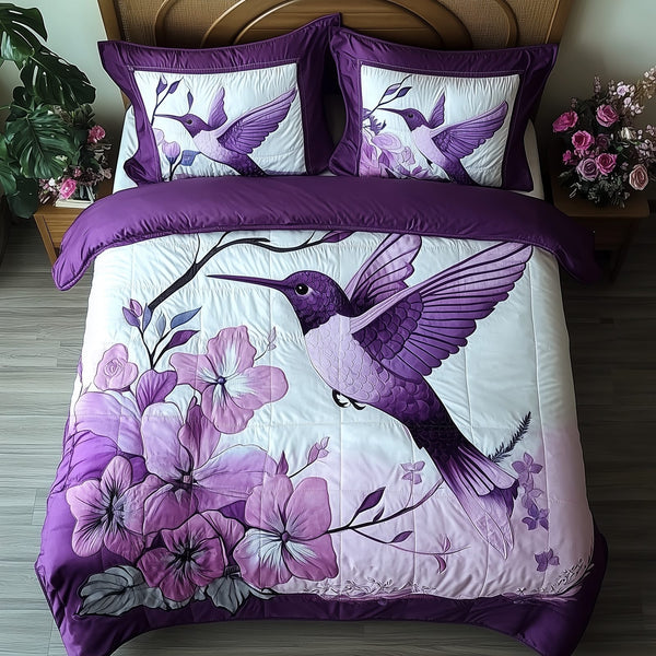 Hummingbird quilted 3-piece bedding set on a made bed with two matching pillow shams